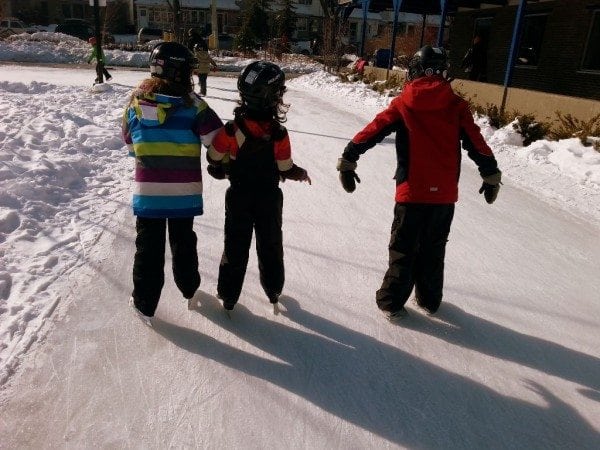 Kids helping kids skate.